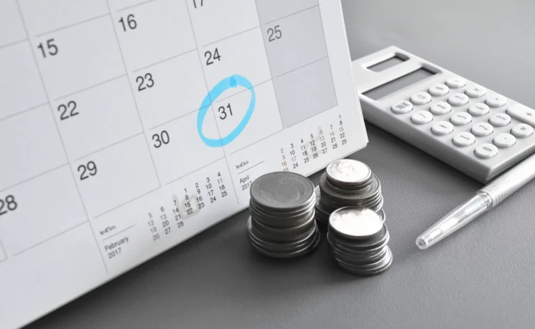 stack of coins with calendar and calculator representing minimum monthly charges