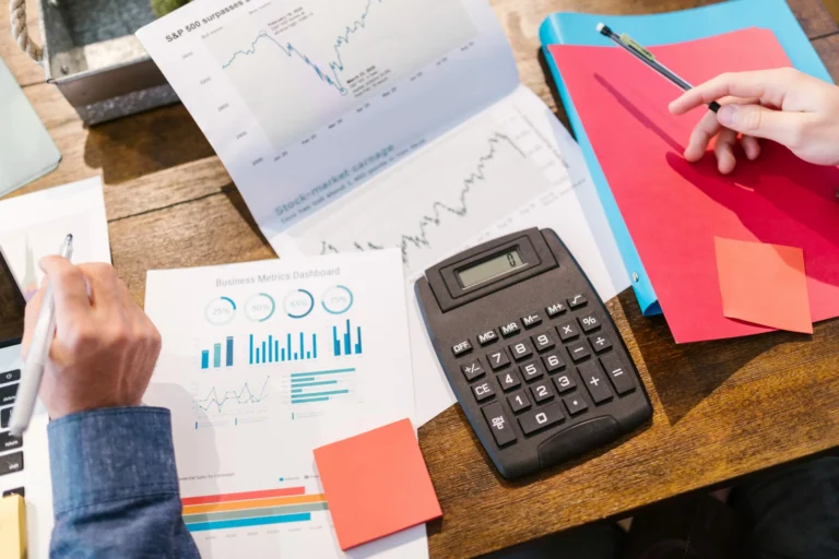 business metrics dashboard and other sheets of paper to show planning for next day funding