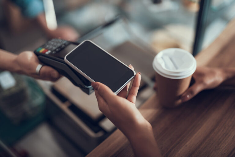 person paying for coffee on phone