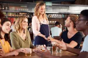 man paying for bill with contactless payment on phone in hospitality business