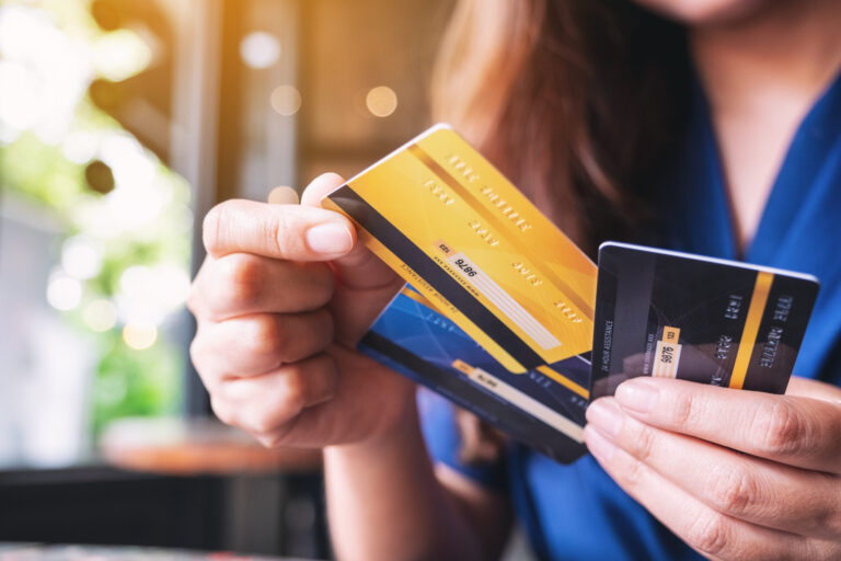 woman holding multiple cards in interchange fee dispute