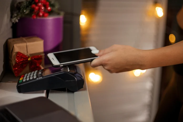 person paying merchant at christmas time on card machine