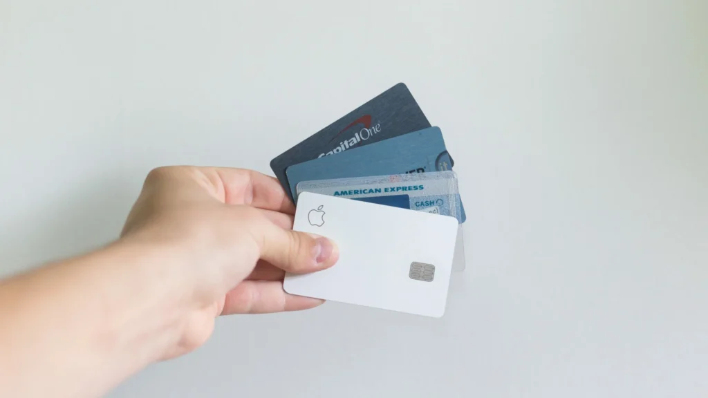 man holding a range of credit cards from different banks to show interchange fees