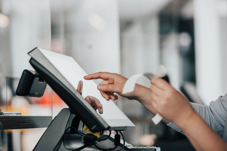 person using epos system and holding receipt