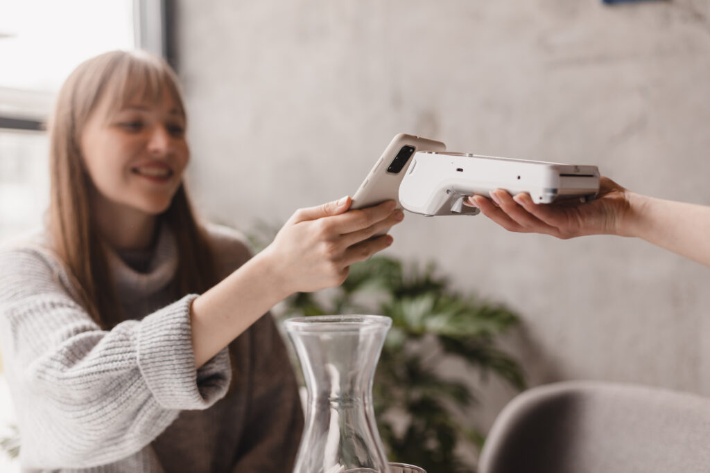 woman paying for a product in a shop with the PAX A920 card machine from Bespoke Merchant Solutions