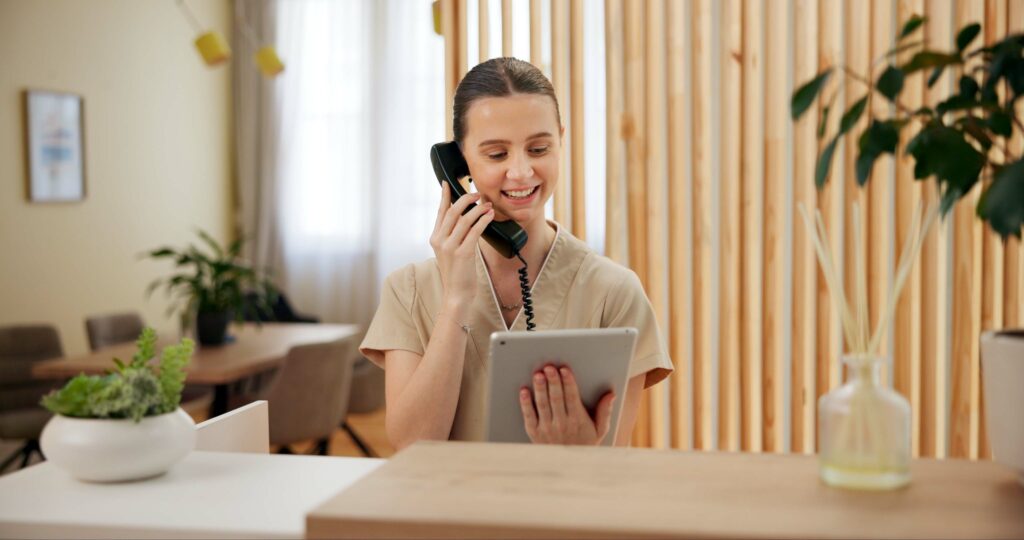 Phone call, spa and woman at reception with tablet checking website for online booking schedule.