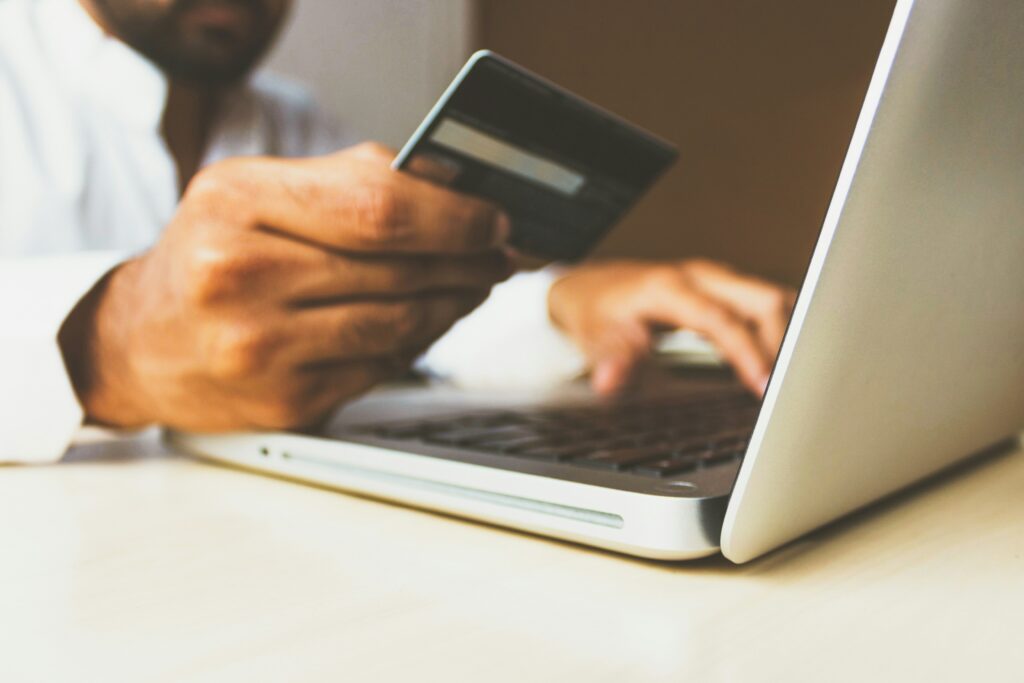 person paying online with high transaction fees