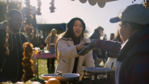 festival vendor taking payment from lady at outdoor market