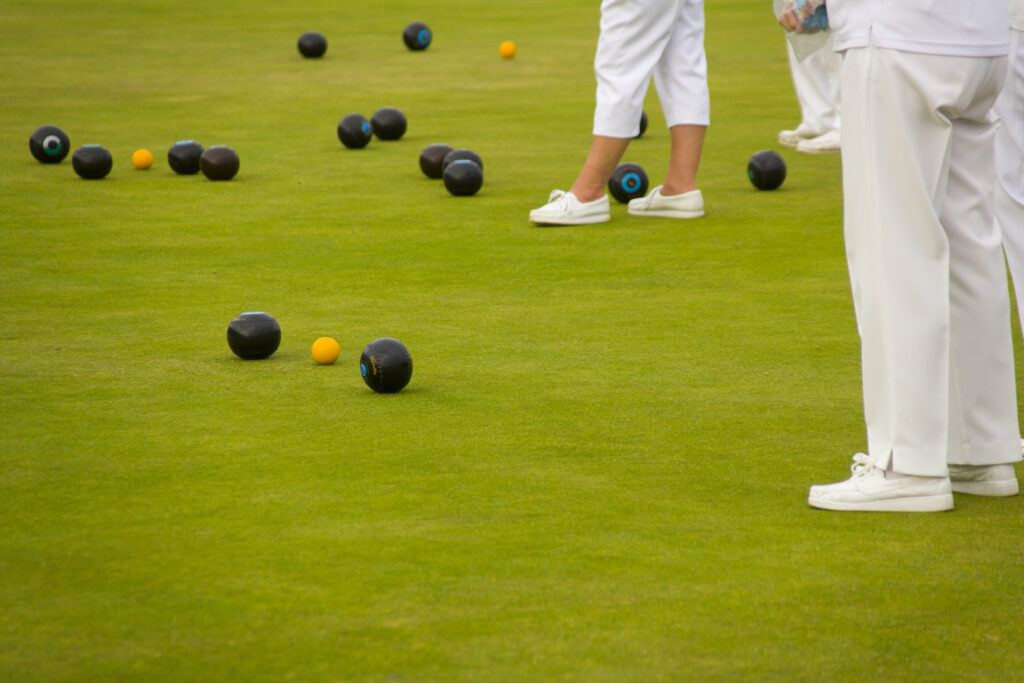bowls and players on a. bowling green representing a bowls club