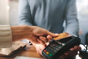 close up of person paying by card representing payments providers