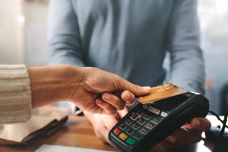 close up of person paying by card representing payments providers