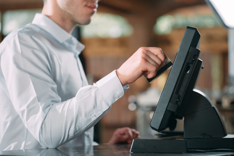 man using epos system to take payment