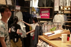 people shopping in clothing store during january sales