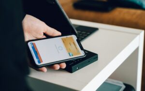 customer tapping phone to pay representing mobile wallets